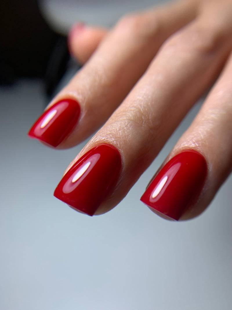 Model wearing mean business vivid cherry gel nail polish | Dolla